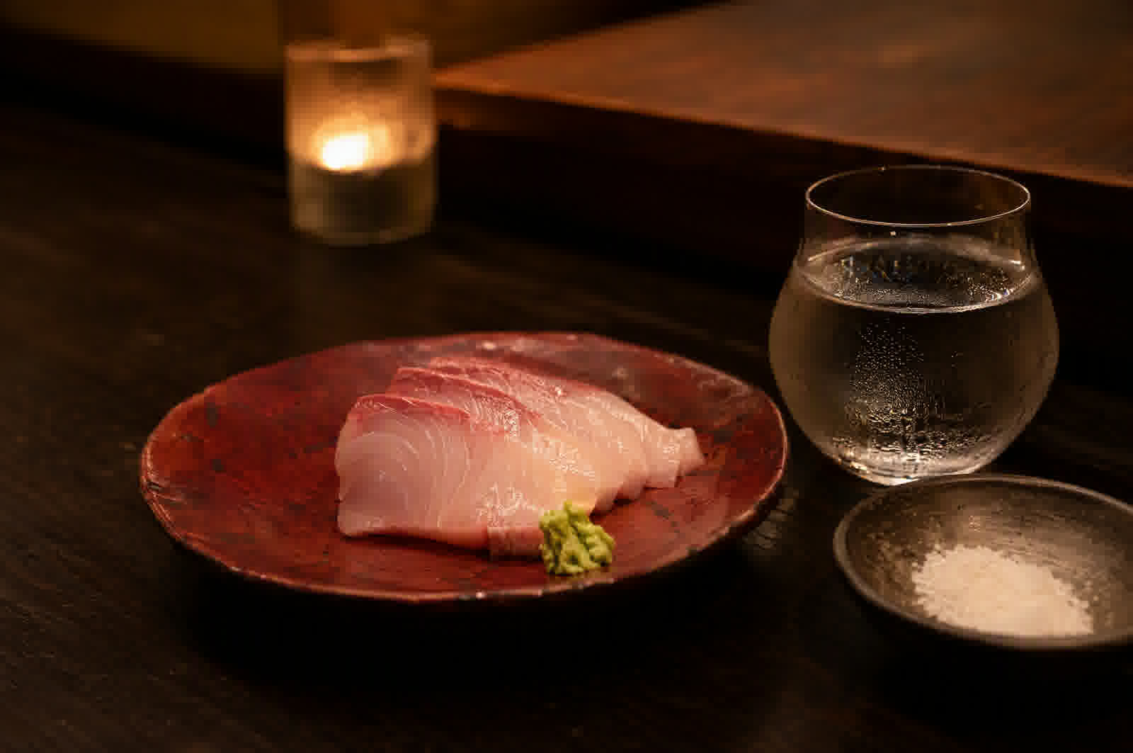 Winter yellowtail sashimi on a dark plate