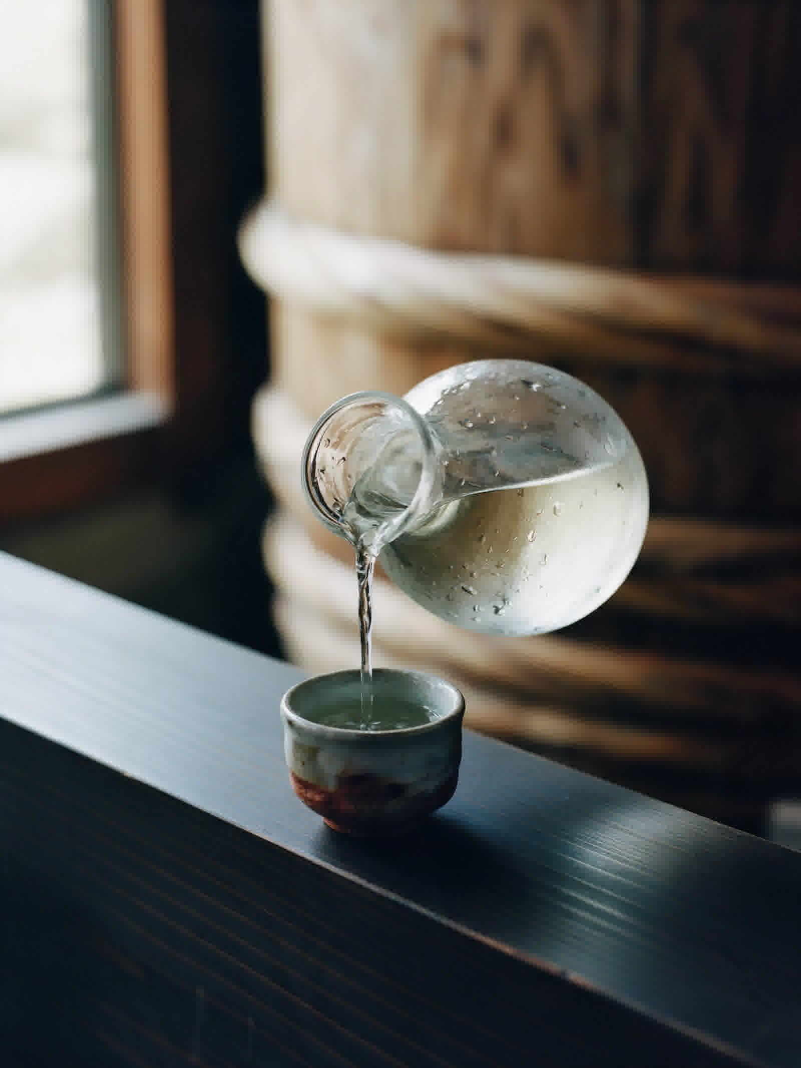 Sake poured into a small cup, close view
