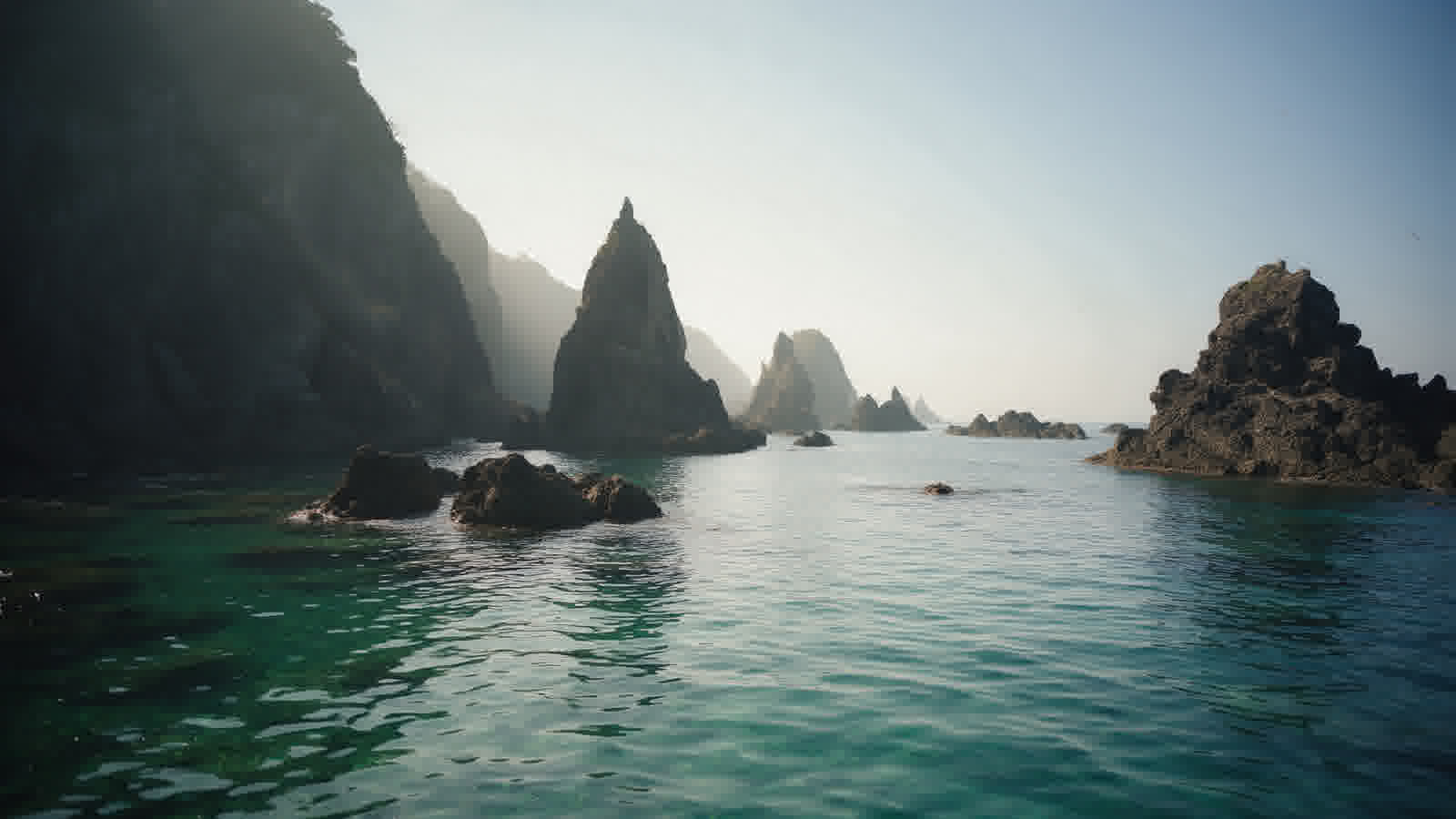 Senkakuwan bays and cliffs, water the colour of bottle glass